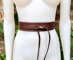 Maroon brown brown  OBI BELT in  genuine leather. Narrower style  Wrap belt in medium-dark brown  color.  Waist belt in soft natural leather. Tobacco brown leather belt. Saddle brown sash. Wraparound brown belt.  The belt is 220 cm (86 in) long and 5  cm ( 2 in)  at its widest (front) it gets smaller towards the end up to 1 cm (1/2  inch).  Our genuine leather and soft suede obi belts  in different colors: https://www.etsy.com/es/shop/goodtimesbarcelona?section_id=10691564 This listing is for th Adjustable Brown Belt With Self Belt Detail, Adjustable Brown Belt, Adjustable Brown Corset Belt With Matching Belt, Fitted Brown Leather Belt, Brown Fitted Leather Belt, Brown Leather Corset Belt With Removable Belt, Brown Fitted Corset Belt With Removable Feature, Brown Leather Fitted Corset Belt, Brown Leather Corset Belt