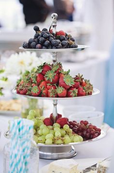 three tiered trays filled with different types of fruit