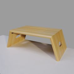 a wooden step stool sitting on top of a white floor