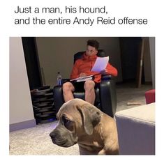 a man sitting in a chair next to a dog