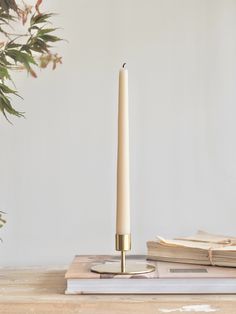 a candle on a table next to some books