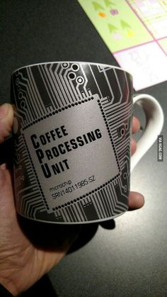 a person holding a coffee mug with the words coffee processing unit printed on it in front of them