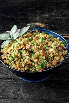 a blue bowl filled with food on top of a wooden table