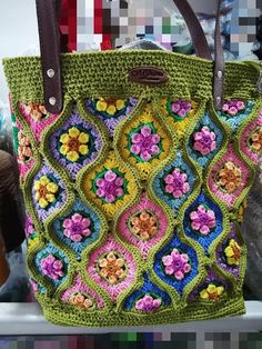 a crocheted bag is sitting on a shelf