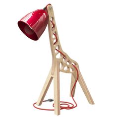 a wooden giraffe lamp with a red shade on it's head and legs