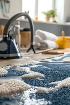 a blue rug with white spots on it and a vacuum in the corner next to it