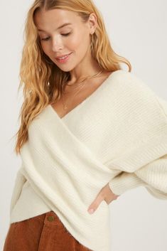 Stay cozy and chic with our Ivory Ribbed Off-the-Shoulder Sweater. Featuring a unique crossover neckline and trendy balloon sleeves, this relaxed-fitness sweater will keep you both stylish and comfortable. Perfect for layering or wearing on its own, this sweater is a versatile addition to any wardrobe! -77% Acrylic 20% Nylon 3% Spandex Fit True to size Sarah is wearing S/M S/M-4 to 8 M/L- 10 to 14 Trendy Balloons, Crossover Sweater, Cross Sweater, Long Balloons, Wrap Sweater, Balloon Sleeves, Shoulder Sweater, Crossover, Clothing Items