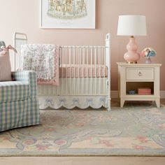 a baby's room with pink walls and furniture