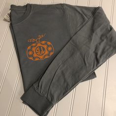 "Welcome to CottonandPearlsVinyl! Okay, now you're talking fall, Halloween and Thanksgiving style all rolled into one with this long sleeve unisex t-shirt that features a cute monogram polka dot pumpkin on the left chest. With so many colors to customize and make it your own, you'll be wearing this super soft tee from September to Black Friday! ❤ ABOUT THIS SHIRT - Long sleeve cotton tee with professional grade, heat transfer vinyl monogrammed polka dot pumpkin on left chest. - Unisex sizes S to Relaxed Fit Long Sleeve Shirt For Halloween, Pre-shrunk Long Sleeve Halloween Shirt, Pre-shrunk Long Sleeve Shirt For Halloween, Long Sleeve Halloween Shirt, Halloween Monogram Shirts, Halloween Monogram, Thanksgiving Style, Fall Monograms, Polka Dot Pumpkin