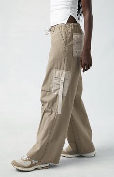 Level up your streetwear style with the PacSun Brown Toggle Baggy Cargo Pants. These on-trend mid-rise pants combine edgy style with comfort, featuring a baggy fit, cargo pockets, and an adjustable toggle waist for a customizable fit. Streetwear Cargo Style Parachute Trousers, Y2k Style Straight Cargo Pants With Pockets, Baggy Y2k Wide Leg Pants With Pockets, Y2k Style Baggy Wide Leg Pants With Pockets, Y2k Straight Cargo Pants With Cargo Pockets, Trendy Loose-fit Cargo Parachute Pants, Trendy Parachute Pants With Cargo Style, Hip Hop High Waist Baggy Parachute Pants, Y2k Cotton Parachute Pants For Streetwear