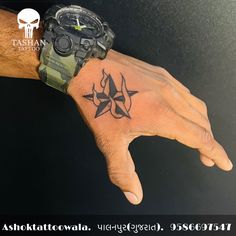 a man's hand with a tattoo on it and a watch in the middle