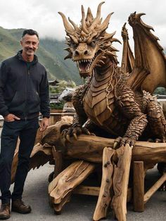 a man standing next to a carved wooden dragon