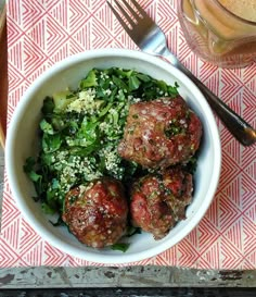 meatballs and greens in a bowl on a table