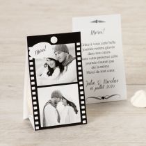 a couple's photo on a card next to some white hearts and paper tags