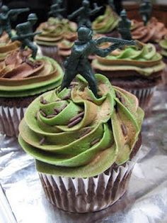 some cupcakes with green frosting and decorations on them