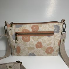 Sweet Romantic Floral Canvas!  This small crossbody bag is the perfect size to take everything you need with you and still be a small size.  The handle is adjustable so you can wear it on your shoulder or in front of you.  The front zipper pocket is perfect for a phone!  I keep mine there for easy access. The bag measures 6" high x 9" wide x 2.5" deep. Top zipper opening is 8.5" long and opens wide. Front zipper opening is 7" long Floral Embroidered Crossbody Travel Bag, Spring Crossbody Bag With Gold-tone Hardware, Spring Floral Print Crossbody Bag, Brown Floral Print Crossbody Shoulder Bag, Multicolor Embroidered Floral Crossbody Shoulder Bag, Floral Handbags, Bag Flower, Small Crossbody Purse, Floral Canvas