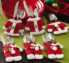 a table topped with silverware covered in santa clause hats and holding utensils