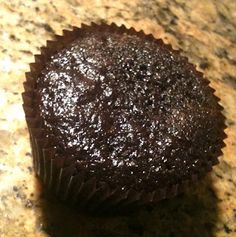 a chocolate cupcake sitting on top of a counter