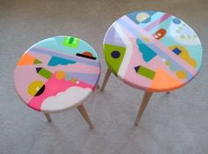 two colorful stools sitting on top of a carpeted floor