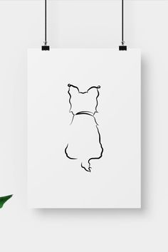 a black and white drawing of a cat's head on a white poster hanging from a wall