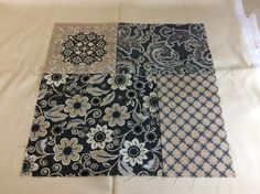 four different types of fabric laid out on top of each other, with white and black designs