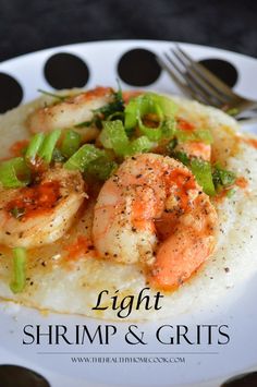 shrimp and grits on a plate with a fork