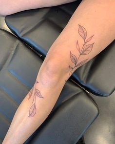 a woman's legs with leaves on them