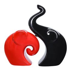 two black and red vases sitting next to each other