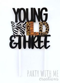 the words young wild and three are made out of wood letters with zebra print on them