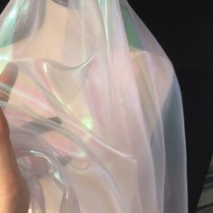 a person is holding a plastic bag with something in it that looks like holographics