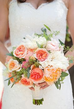 a bride holding a bouquet of flowers in her hands