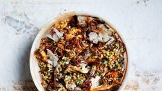 a white bowl filled with food on top of a table