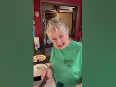 an old woman is cutting up some food