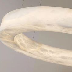 a large white sculpture hanging from the ceiling