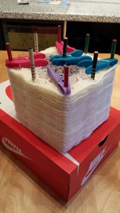 a cake made to look like a boat with umbrellas on it sitting on top of a box