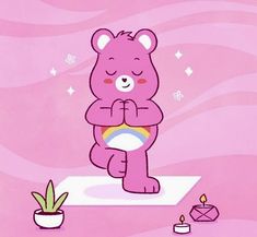 a pink teddy bear sitting on top of a rug