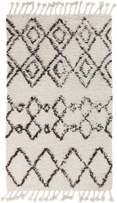 a white and black rug with fringes on the bottom, in different shapes and sizes