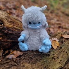 a stuffed animal sitting on top of a tree branch