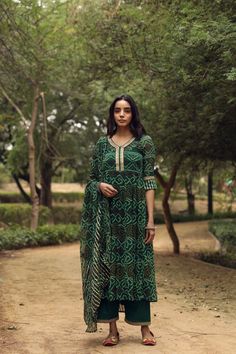 Green Bandhani Print Anarkali Suit Set The set consists of bandhani print anarkali kurta with round neck, 3,4th sleeves teamed with solid palazzo pants with lace detailing and dupatta with gota detailing to match. Kurta Length-48 inches Palazzo Length- 36 inches Dupatta Length-2.5 meters Work-Bandhani Print Color-Green Fabric-Cotton Sleeves - 3/4th Sleeves Neck-Round Washing Care-Dry Clean Bandhani Print Anarkali, Bandhani Anarkali, Printed Anarkali Suits, Pants With Lace, Bandhani Print, Sharara Suit, Anarkali Kurta, Anarkali Suit, Indian Ethnic Wear