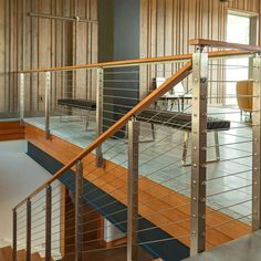 the inside of a building with wood and metal railings