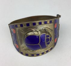 This is truly a unique vintage cuff bracelet Art Deco This is a must for a collector of Egyptian inspired jewelry It is from the early to mid 20th Century.  This brass piece features a large cloisonne scarab beetle crafted in blue enamel The sides feature cloisonne lotus and other designs It is hinged with a pin closure Please note that I only ship domestically in the United States...thanks Edwardian Fashion Dresses, Egyptian Inspired Jewelry, Vintage Cuff Bracelet, Bracelet Art, Scarab Bracelet, Egyptian Inspired, Art Deco Bracelet, Scarab Beetle, Cufflink Set