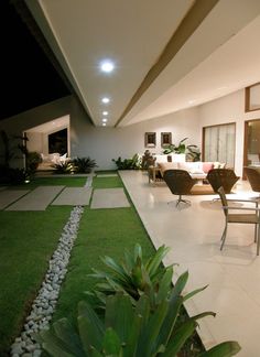 an open living room and dining area with artificial grass