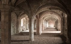 the inside of an old building with stone arches