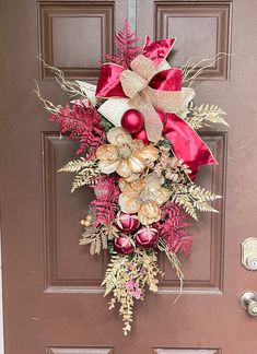 a red and gold christmas wreath on the front door