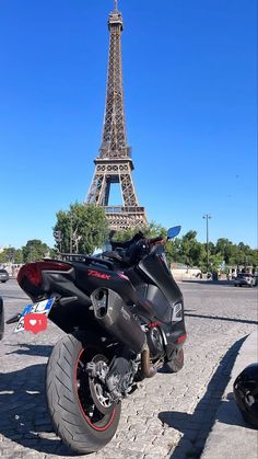 a motorcycle parked in front of the eiffel tower