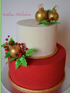 a christmas cake decorated with holly and gold ornaments