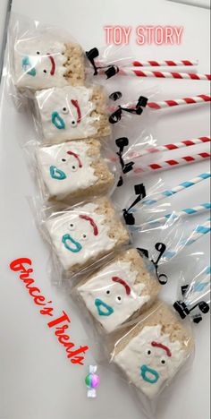 some kind of marshmallows with faces on them and candy sticks in the middle