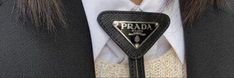 a person wearing a tie with the word prada on it's lapel