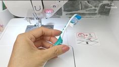 someone is using a sewing machine to sew the toothpaste on their teeth