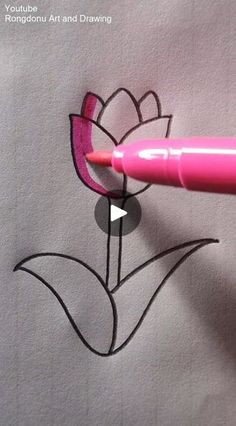 someone is drawing a flower with pink marker